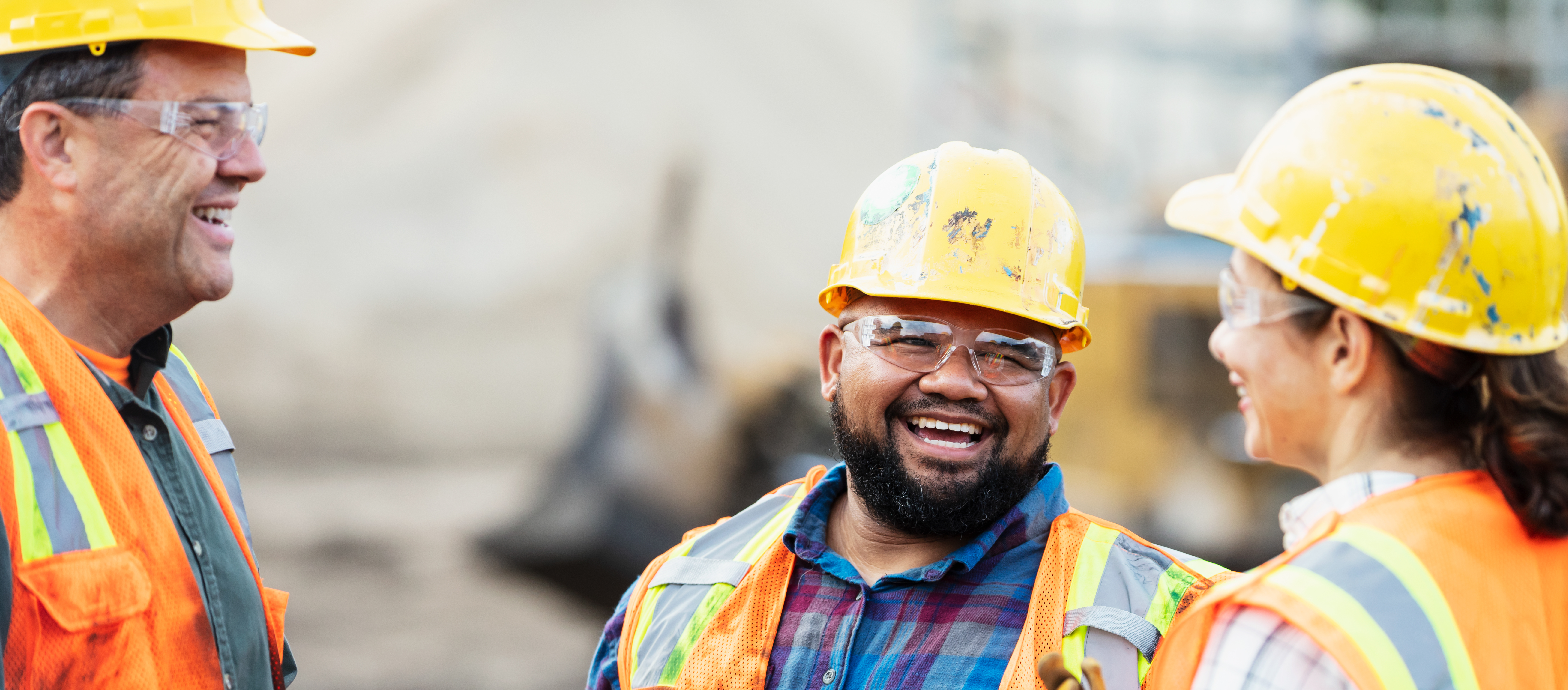 Three construction workers laughing